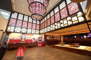 a shopping mall with a chandelier and windows at Hotel New Akao in Atami