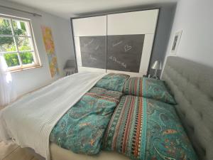 a bedroom with a large bed and a large window at Ferienwohnung BONHEUR im Kunsthaus 