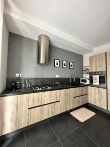 a kitchen with wooden cabinets and a stainless steel appliances at Loft al mare Porto San Giorgio in Porto San Giorgio