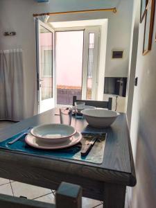 a table with plates and bowls on top of it at Casina Tecla in Cavo