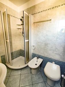 a bathroom with a shower and a toilet and a sink at Casina Tecla in Cavo +9 photos