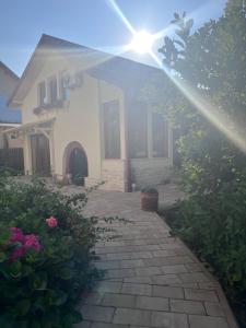a house with the sun shining on a patio at Casa Izac in Botoşani