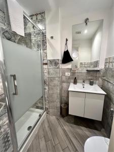 a bathroom with a shower and a sink at Spagna Rooms in Rome