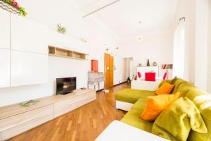 a living room with a green couch and a fireplace at Bernardo House by Holiday Home 24 in Genova