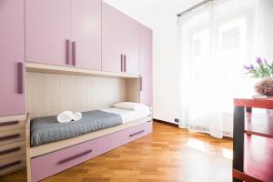 a bedroom with a bed with two towels on it at Bernardo House by Holiday Home 24 in Genova