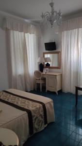 Cama ou camas em um quarto em Hotel La Perla