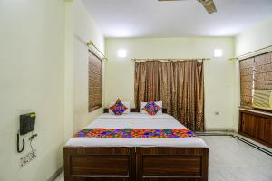 a bedroom with a bed in a room at FabExpress Ullash Residency in Kolkata