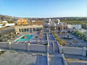 an aerial view of a house with a swimming pool at En Plo Boutique Suites Oia Santorini in Oia