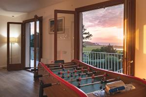 a room with a foosball table in front of a window at La Villa Maxine, vue mer et spa in Criel-sur-Mer