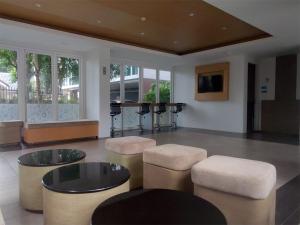 a living room with stools and a table and a piano at Superbe Studio avec Salle De Bain Privee Kata Beach Phuket Phuket in Kata Beach