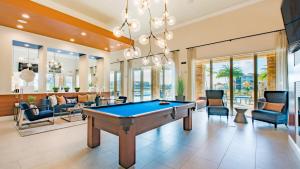 a pool table in a living room with furniture at Miramar 2BR w gym pool wd nr WF MIA-23 in Miramar