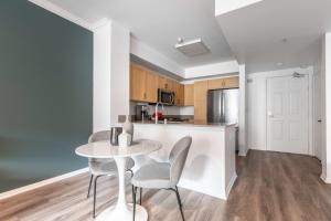 a kitchen and dining room with a table and chairs at Hollywood 1BR w Gym Pool Spa nr Sunset Blvd LAX-231 in Los Angeles