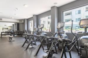 a fitness room with treadmills and elliptical machines at Hollywood 1BR w Gym Pool Spa nr Sunset Blvd LAX-231 in Los Angeles