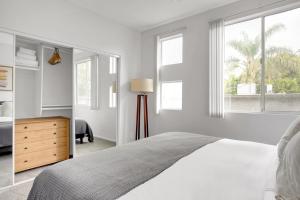 a white bedroom with a bed and windows at Sherman Oaks 2BR w WD nr WF TJ LAX-778 in Los Angeles +19 photos