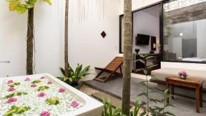 a room with a bathtub with flowers on it at Lynnaya Urban River Resort in Siem Reap