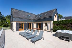 a group of chairs sitting on a patio at La Villa Maxine, vue mer et spa in Criel-sur-Mer