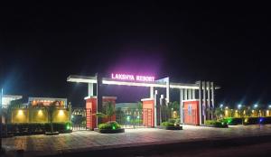 a gas station with a lit up sign at night at Lakshya Resort in Gorakhpur