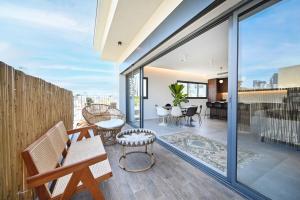 an open living room with a balcony with sliding glass doors at Modern 3BR retreat in the Old North by HolyGuest in Tel Aviv