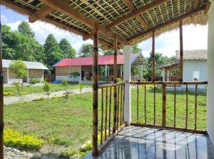 a view from the porch of a house at Falcon Jungle Resort in Jyoti Gaon