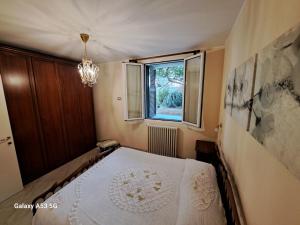 a bedroom with a bed and a window at La Morena in Taggia