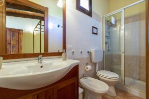 a bathroom with a sink and a toilet and a shower at Studio Lo Scrigno in Porto Torres