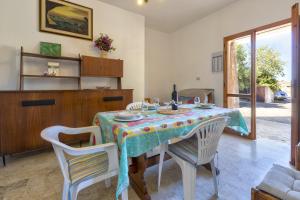 a dining room with a table and two chairs at Casa Foca Lu Bagnu in Castelsardo