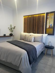 a bedroom with a large bed with a window at Lagoon Lodge in Cape Town +60 photos