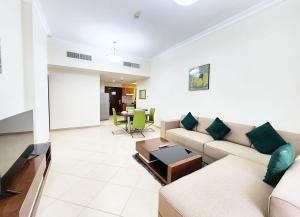 a living room with a couch and a table at RH- Convenient 1BR, Central, near Mall of Emirates, Al Barsha1 in Dubai