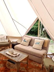 a living room with a couch in a tent at The Toad's pad in Tiverton