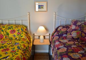A bed or beds in a room at Bloomsbury House - Magical Coastal Retreat - Crabpot Cottages