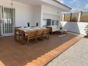 a dining table and chairs on a patio at Casa Limonero in Denia