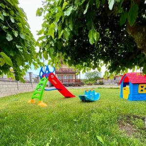 a group of childrens play equipment in the grass at Casa Luca 2 in Vama Veche