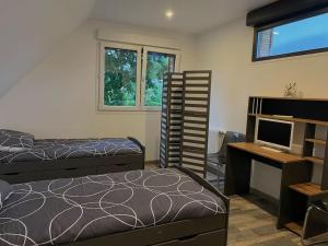 a bedroom with two beds and a desk and a computer at Paisible Duplexe sur Villeneuve d ascq in Annappes +67 photos