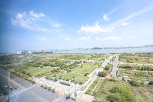 an aerial view of a park with a river and a city at Romang House in Incheon