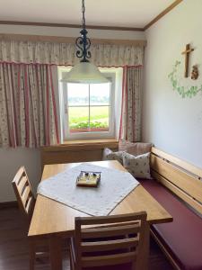 a dining room with a table and a window at Plombergbauer in Sankt Gilgen