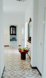 a hallway with a vase of flowers on the floor at Il Paradiso Di Hyele in Ascea