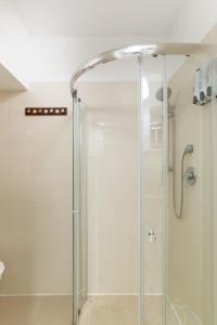 a shower with a glass door in a bathroom at Sea View 2 bedroom apartment with Bomb Shelter in Tel Aviv