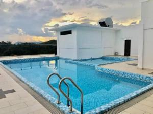 a large swimming pool with blue water at GR studio APARTMENT 1 - kompleks MUTIARA gua MUSANG in Gua Musang
