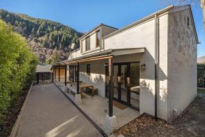 a building with a bench on the side of it at Beautifully styled central home in Queenstown
