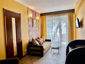 a living room with a couch and a window at Villa ReTa Hotel & SPA in Grigoleti