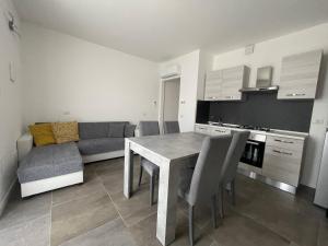 a kitchen and living room with a table and a couch at IseoLakeRental - Casa Il Nido in Fonteno +7 photos