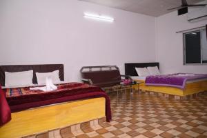 Postel nebo postele na pokoji v ubytování Chang Ghar Resort