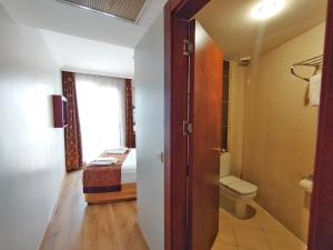 a bathroom with a toilet and a bed in a room at Orient Mintur Hotel in Istanbul +37 photos