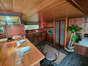 a kitchen with a long wooden table and chairs at Peniche relaxant in Sèvres