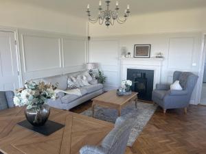 a living room with a couch and a table at Castellor Bed & Breakfast in Cemaes Bay