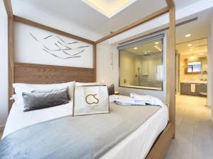 a bedroom with a large bed with a sign on it at Hotel Cala Saona & Spa in Cala Saona