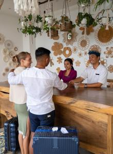 a group of people standing around a counter at Mambo Hill Resort in Nusa Penida