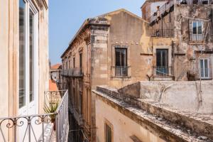 a view of an old building from a balcony at Casa Mia a Ortigia by Wonderful Italy in Syracuse