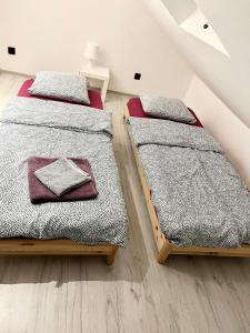 two twin beds in a attic bedroom at Open Space Apartment in Belgrade