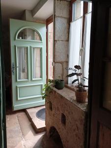 a door in a room with two potted plants on a ledge at Mine d'Ore in Thoste